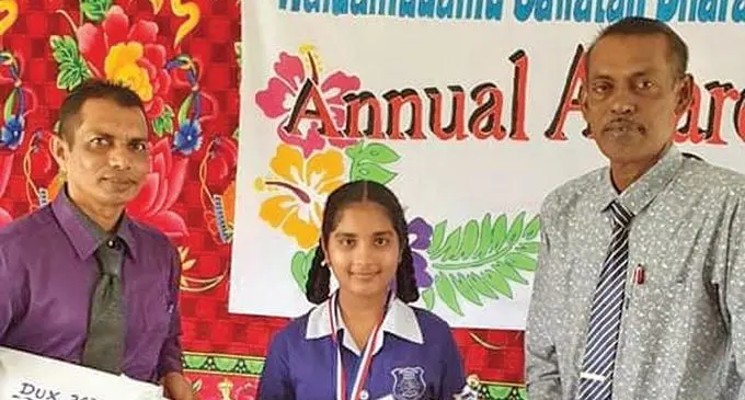 From left; Rakesh Chand (father), Dux awardee Ryna Rishika Chand and Gaj Raj (head teacher) during the prize giving  ceremony at Waidamudamu Sanatan Dharam Primary School on December 15, 2020.