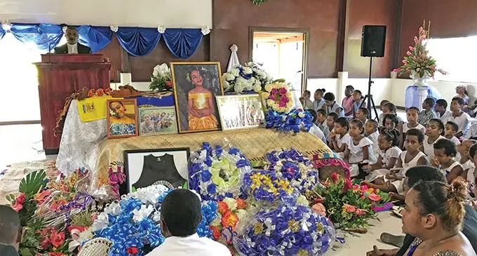 Families and friends surrounding the casket of the late Joana Mele Vuetaki at her homecoming service in Tuvasu Hall at the Queen Elizabeth Barracks in Nabua on March 2, 2019 .  Photo: Ashna Kumar    