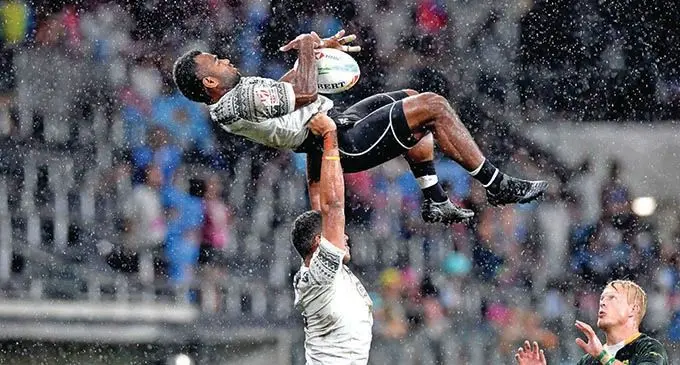  Seremaia (Jerry) Tuwai is lifted by Meli Derenalagi to claim a restart during the HSBC World Sevens Series. Photo: World Rugby