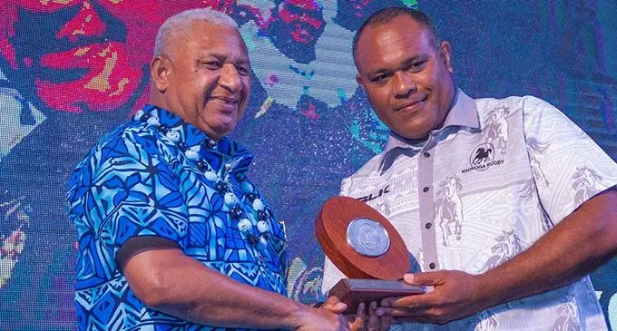 Nadroga Rugby Union president Tiko Matawalu receiving his Administrator of the Year award from Prime Minister Voreqe Bainimara at the FIji Rugby Awards night
