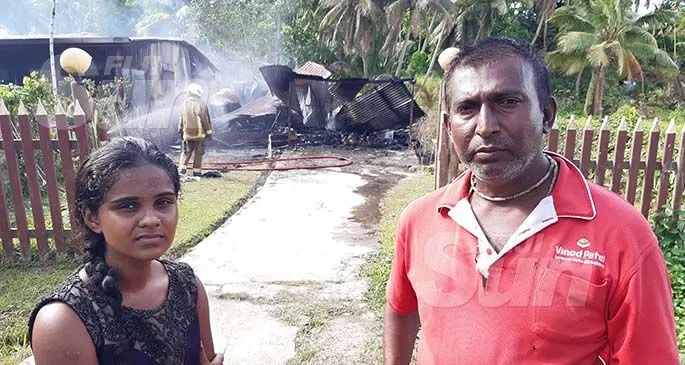 Darshika Singh and her step-father Parvin Datt standing in front of their home in Vusuya Nausori. The fire destroyed two homes on January 9, 2020. Photo: Shalveen Chand