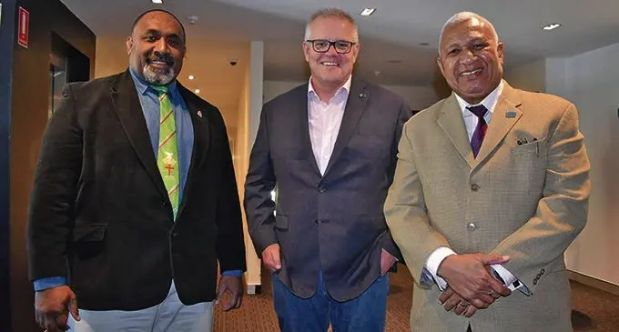 Prime Minister Voreqe Bainimarama (right) with Australian Prime Minister Scott Morrison (middle) and a Fijian in Sydney.