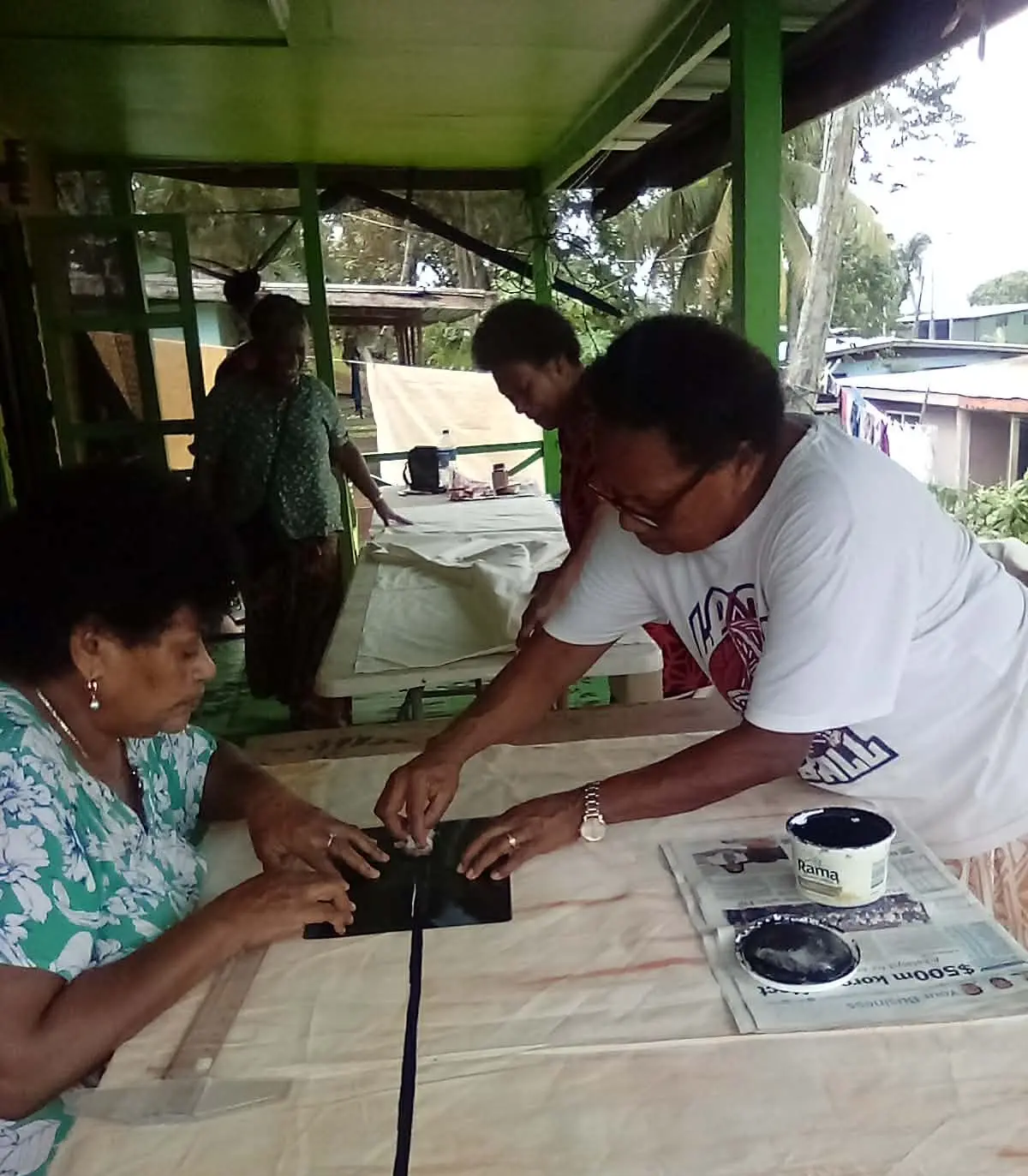 Asinate Kama (left) assisting participants how to do screen printing in Vunidogoloa Village in Cakaudrove on May 8, 2026.