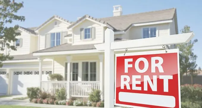 For Rent Real Estate Sign in Front of House