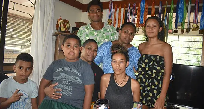 From left: Issac Wedlock (grandson), Robert Ross, Makita Ross (wife), Mere Ross holding her father’s picture, Seleni Ross, Mereani Wedlock (niece), and Netani Ross at their home in  Nasoso Nadi. Photo: Mereleki Nai 