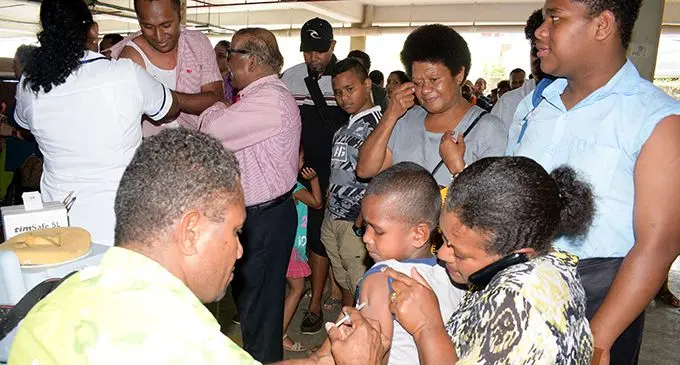 A Suva Medical Centre staff member (left), assists Alitia Ragele and son Seveci Ravetau, 7, with free measles vaccination on November 19, 2019.  Photo: Ronald Kumar
