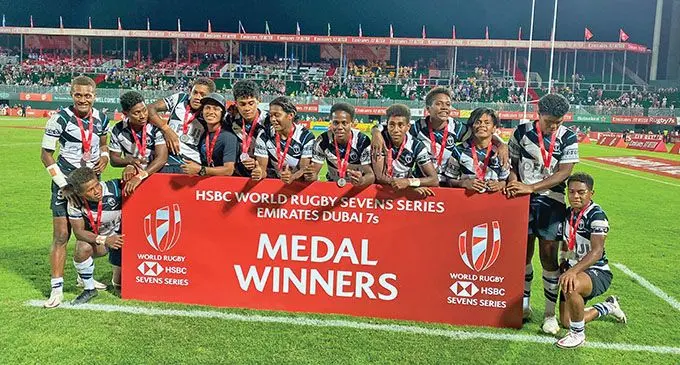 Fiji Airways Fijiana 7s team after reaching their second Cup final of the World Sevens Series in Dubai on December 4, 2021. Kneeling (from left) Lavena Cavuru and Mereani Rogosau. Standing (from left) Aloesi Nakoci, Ana Maria Naimasi, Vasiti Solikoviti, Josua Mataitoga (physio), Sesenieli Donu, Laisana Likuceva, Raijeli Daveua, Reapi Uluinasau, Vani Buleki, Ana Maria Roqica, Rusila Nagasau (captain). Photo: World Rugby