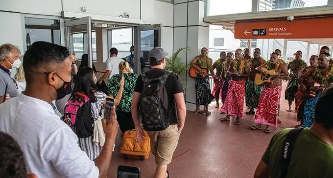 The first group of international tourists receive a rousing ‘Bula’ welcome at the Nadi International Airport on December 1, 2021.  Photo: Leon Lord