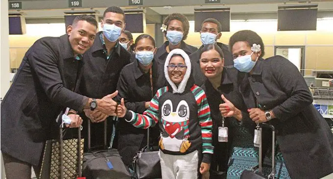 A proud Fijian poses with Fiji Airways crew members at the Vancouver International Airport on November 28, 2022. Photo: Selita Rabuku