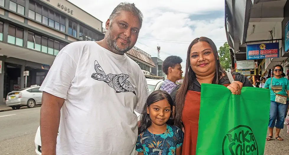 Aaniyah Bezalel with her parents Bimlesh Prasad, left, and Komal Kiran after their back-to-school shopping in Suva on January 9,  2024. Photo: Leon Lord