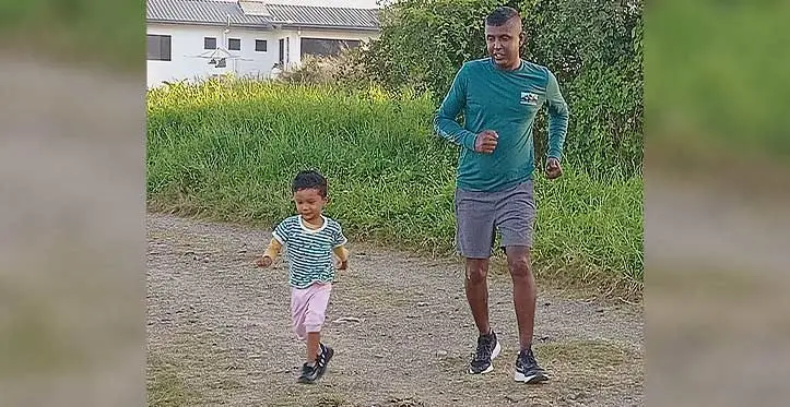 Jet Runners Club president and race director Abhinesh Kumar with his 2-year-old son Abhishal Kumar during their warm up before training in Nadi. Photo: Waisea Nasokia