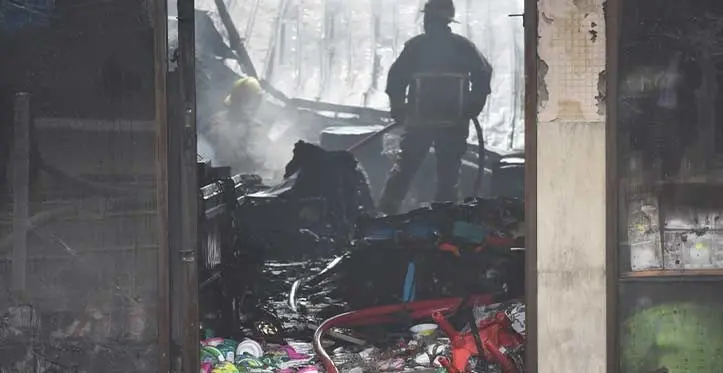 A scene of devastation in Labasa Town on August 29, 2023, as firefighters check one of the seven shops that was destroyed in the fire to see that flames have been put out. Photo: Jone Salusalu