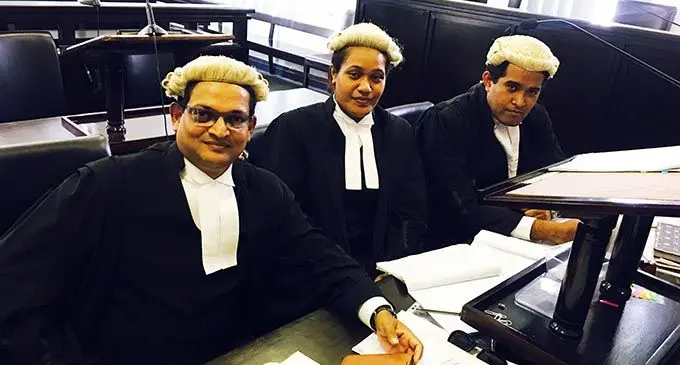 Susan Serukai (middle) with colleagues at the Suva Court.