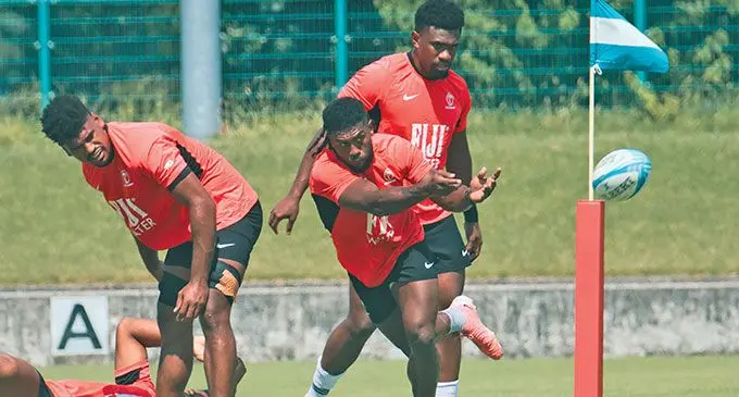 Flying Fijians halfback Frank Lomani delivers a pass as Vuate Karawalevu looks on during training in Tokyo, Japan, on September 12, 20224. Both players are members of the Fijian Drua. Photo: FRU Media