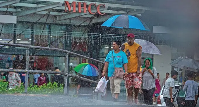Members of the public look for cover as Suva experience heavy rain on January 2, 2025. Photo: Leon Lord