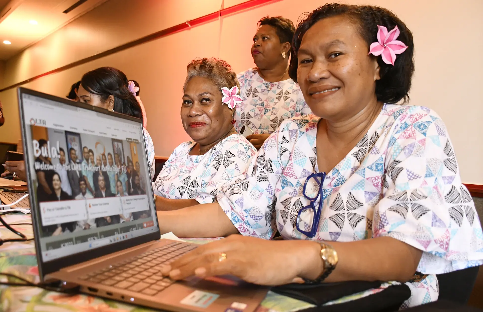 Land Transport Authority staff Talelala Maraiwai and Sera  Digogo with their new revamped e-service and website following the launch in Suva on December 23, 2025. 