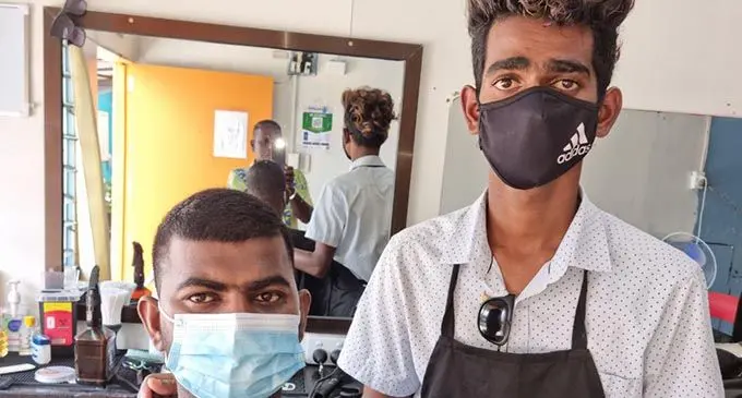 Barber Sharan Chand with one of his customers, Vinay Chand at his shop in Labasa Town on September 28, 2021. Photo: Sampras Anand