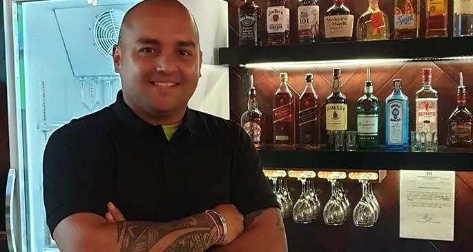 Julius, the experienced mixologist, at Moments Bar.