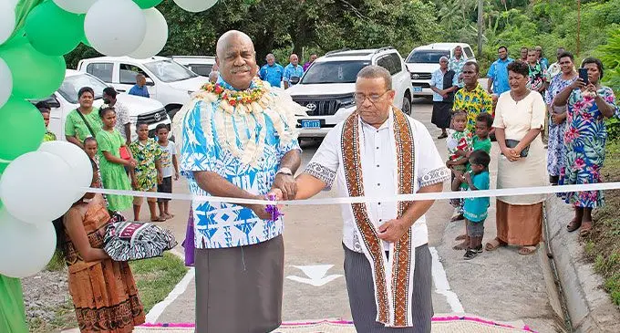 Assistant Minister in the Office of the Prime Minister Sakiusa Tubuna (wearing garland) cuts the ribbon alongside a church minister to officially commission a new access road in Wailailai, Ovalau, on November 1, 2024. Photo: DEPTFO News
