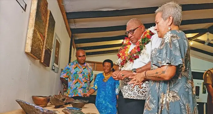 Savusavu artist, Lynne Mclaren, shows her work to President Ratu Wiliame Katonivere, at the opening of the inaugural Savusavu Art and Fashion Week ,on March 28, 2023. Photo: Sampras Anand