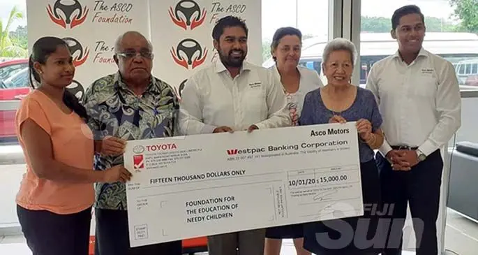 Asco Motors chief executive officer Craig Sims (third from left) hands over a cheque of $15,000 to FENC Fiji national co-ordinator Ratu Meli Vesikula (second from right) on January 10, 2020, at the company’s showroom in Nabua. Photo: Shreeya Verma