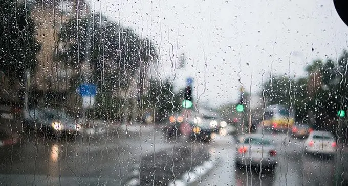 Fiji rain view to street through rain-specked window