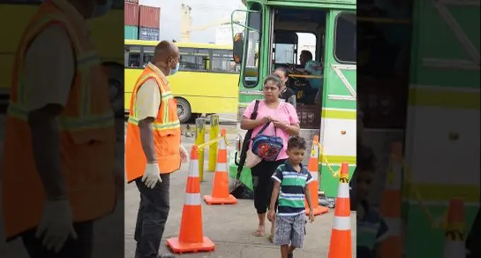 Suva City Council enforcement officer Jope Kete (left) monitors people’s movement at Suva bus stand as cone been placed at the bus stand for people to practice social distancing on March 31, 2020. Photo: Ronald Kumar.