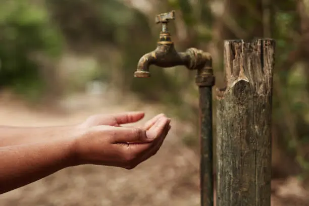 During the dry spell, families are forced to walk about 20 minutes to a nearby home to collect water in small containers.