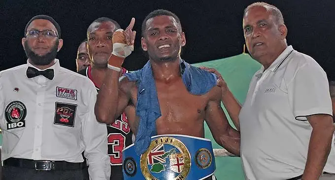 Jese Ravudi (middle) with his title at Prince Charles Park in Nadi. Promoter Mohammed Saneem is on the right. Photo: Waisea Nasokia