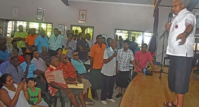 Prime Minister Voreqe Bainimarama listen to a concern raised by a resident of Olosara at the Sai Centre in Sigatoka yesterday. Photo: WAISEA NASOKIA