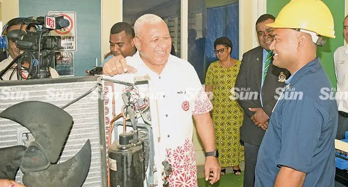 Prime Minister Voreqe Bainimarama with Nasinu Corrections Vocational Centre air-con and electrical lecturer Om Prakash during the inmates graduation on May 31, 2022.  Photo: Ronald Kumar