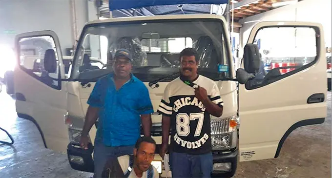 (Standing far left) Koro Village youth club advisor Waisea Ravai, club leader Deve Toganivalu and club secretary Sikeli Nabenia (kneeling front).