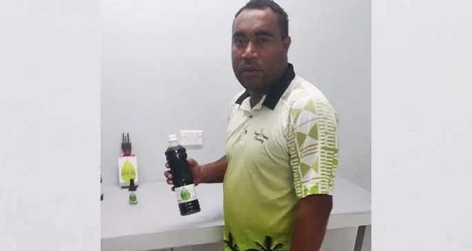 Service Manager Mark Rodan holding one of their products at the factory in Lami.