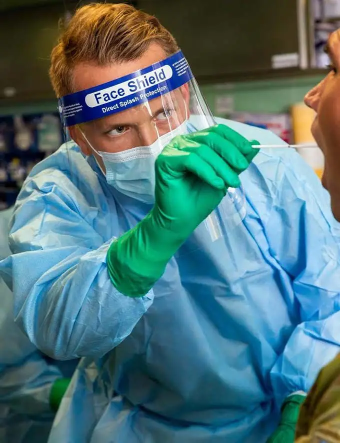 Australian Army Nursing Officer, Lieutenant John Langley from the Maritime Operational Health Unit, conducts a COVID-19 test onboard HMAS Adelaide as part of the COVID-19 safety protocols for Operation Fiji Assist. Photo: Australian Defence Force
