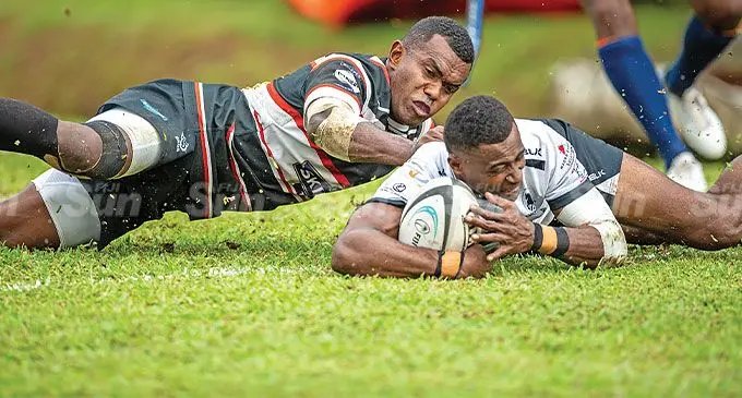 BLK Nadroga rugby winger Jone Dukumoi scores one of his two tries despite an attempted tackle by Naitasiri full-back Etonia Rokotuisawa during the Skipper Cup semifnal at Ratu Cakobau Park, Nausori, on June 15, 2024. Nadroga won 21-17 to face FMF Suva in this Saturday’s Skipper Cup grand-final. Photo: Leon Lord