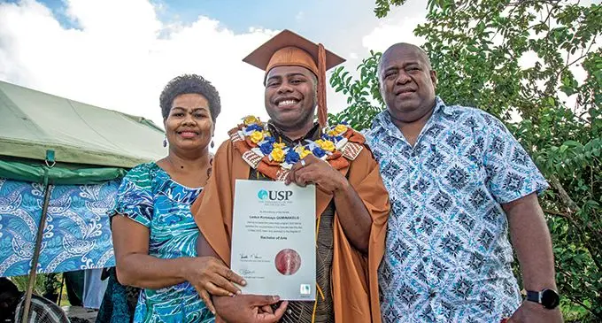 Graduate Ledua Quminakelo flanked by his parents Laisani Marama (mother) and Ratu Amani Quminakelo (father) at their home in Caubati after graduating from the University of the South Pacific on May 12 , 2022. Photo: Leon Lord