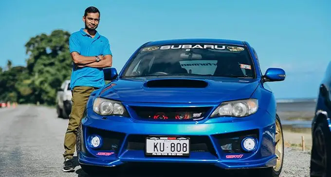 Ashaf Khan beside his car.