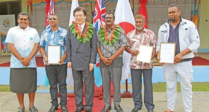 Ambassador of Japan to Fiji, Masahiro Omura (3rd from left) and Minister Praveen Bala with OISCA graduates at Nasau in Sigatoka. Photo: Emi Koroitanoa.