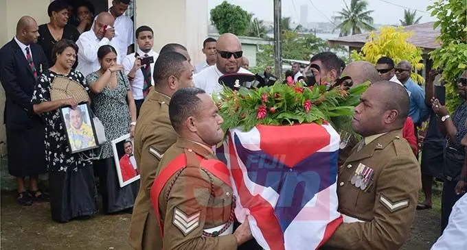 Fijian British Army Soldiers carry the casket of late Ifereimi Custine Tui Vasu as the wife, Marian Vasu and daughter, Kiti Vasu (both with photos) at Suvavou Village on December 17, 2019. Photo: Ronald Kumar.