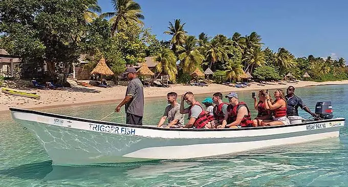 Tourists take a boat ride around the Yasawas