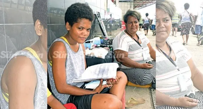 17-year-old daughter Adi Salasaini Tabakaucoro studying for her Year 12 exam on roadside as she assists her mother, Mary Danford, 40, selling items in Suva on February 9, 2022. Photo: Ronald Kumar