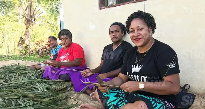 Camari Baisagale (far right) makes traditional sasa brooms with relatives at Sabeto Village in Nadi. Photo: Waisea Nasokia