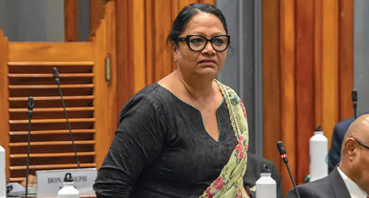 A photograph of Opposition MP Premila Kumar at a microphone.