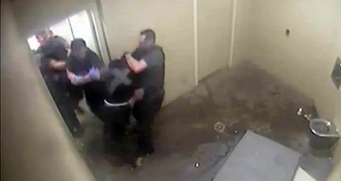 The footage shows police putting Mr Martin in a headlock.