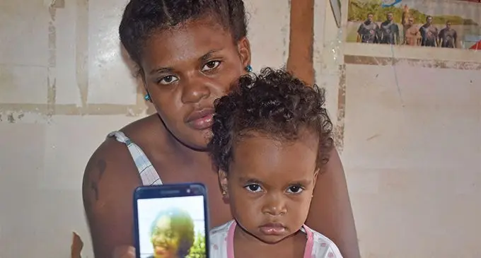 Selina Nabeqa and daughter holding a picture of the deceased, Kinisimere Marama. Photo: Mereleki Nai