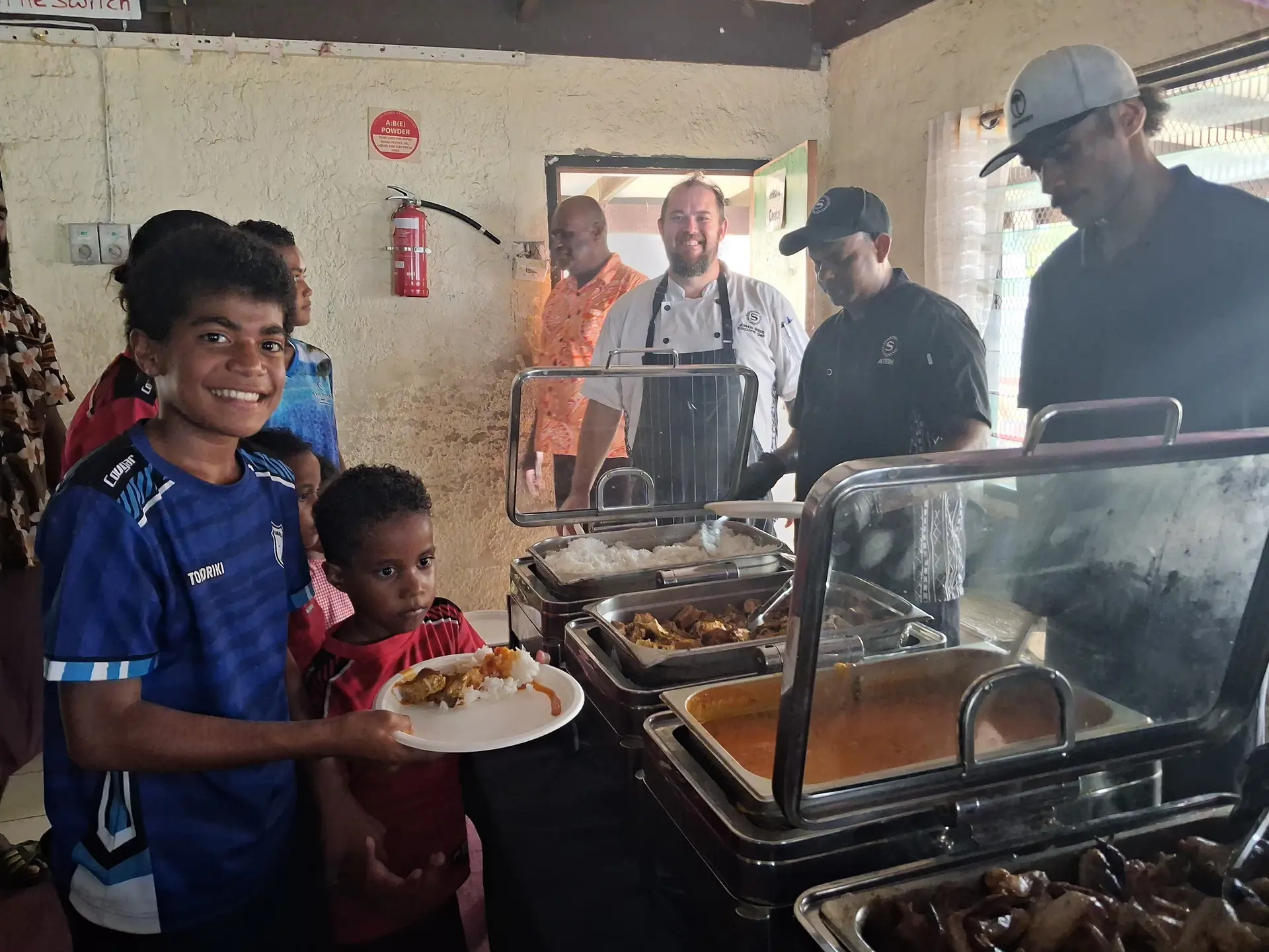 Aseri Natoma with Litiana Navuga gets served with their lunch from the chefs of Sheraton Fiji Resort and Spa, Tokoriki Island, Fiji. 