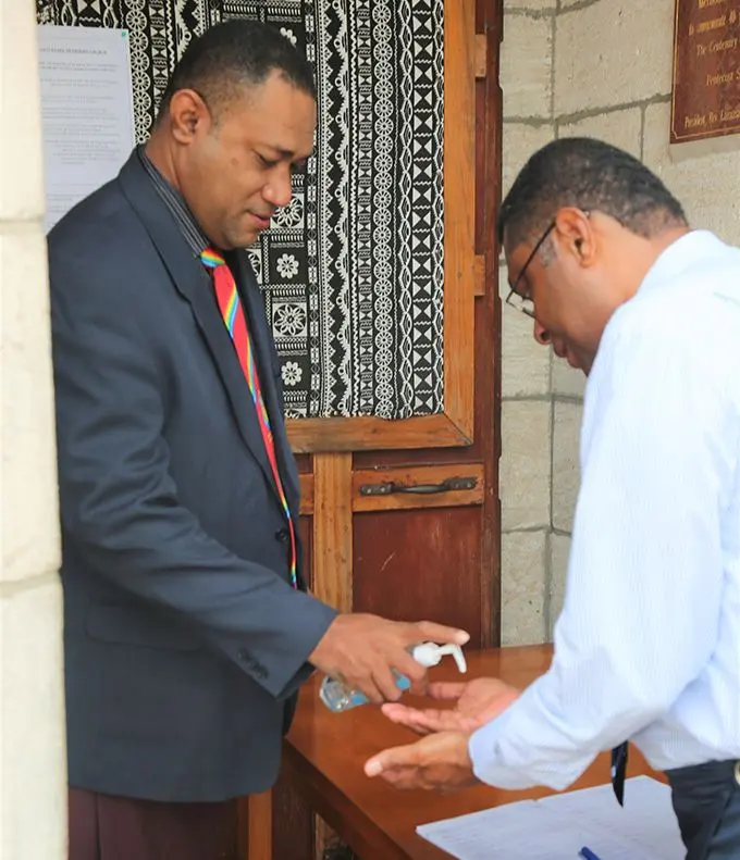  Ministry of Health Chief Medical Advisor, Doctor Jemesa Tudravu (left) gets his hands sanitised before entering the Centenary Methodist Church on June 28, 2020.   Photo: Inoke Rabonu