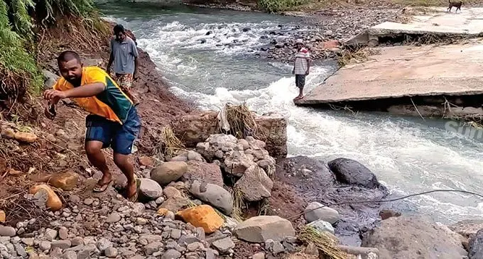 Deo Karan road committee president Aman Ravi Chandra (front,), Ashok Kumar and Jai Chand manage to cross the Deo Karan Road Irish crossing in Paipai ,Lautoka after flood waters receded on February 9, 2022.  Photo: Salote Qalubau