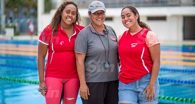 Barracuda Swimming Club coach, Rosemary Rova is flanked by her daughters Cheyenne (left) and Rosemarie after they won their respective events at the National Aquatic Centre on November 16,2020. Photo: Leon Lord