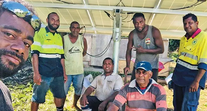 Left: Nakawaqa Village headman, Henry Koliniwai, with villagers and personnel from the Mineral Resouces Department during the installation of the solar water pump on April 11, 2022.